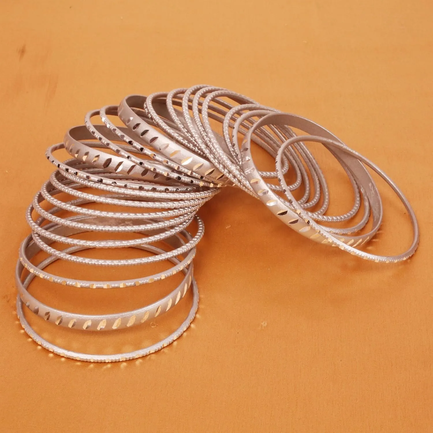 Touchstone Indian Bollywood Fashion Handcrafted Cut Metal Grain Work Textured Wrist Beautifier Magical Designer Jewelry Bangle Bracelets. Set of 24. for Women.